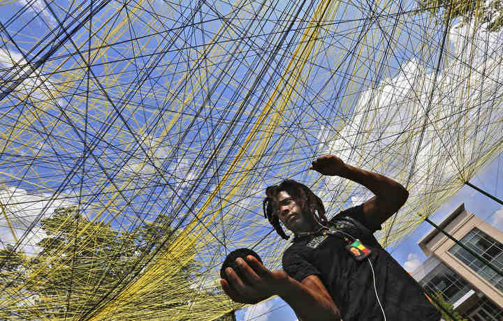 Jacolby Wilson a junior at Ohio Dominican University stretches yarn through the Unity project on the center of campus September 21, 2018. A participant in the project stretches yarn between 32 poles that are different indentifiers such as, I am a student, I am a survivor, I believe in a higher power. The project creates a web to call attention to diversity and promotes unity on campus.  They have had over 200 participants so far.[Eric Albrecht/Dispatch]  (Eric Albrecht / The Columbus Dispatch)